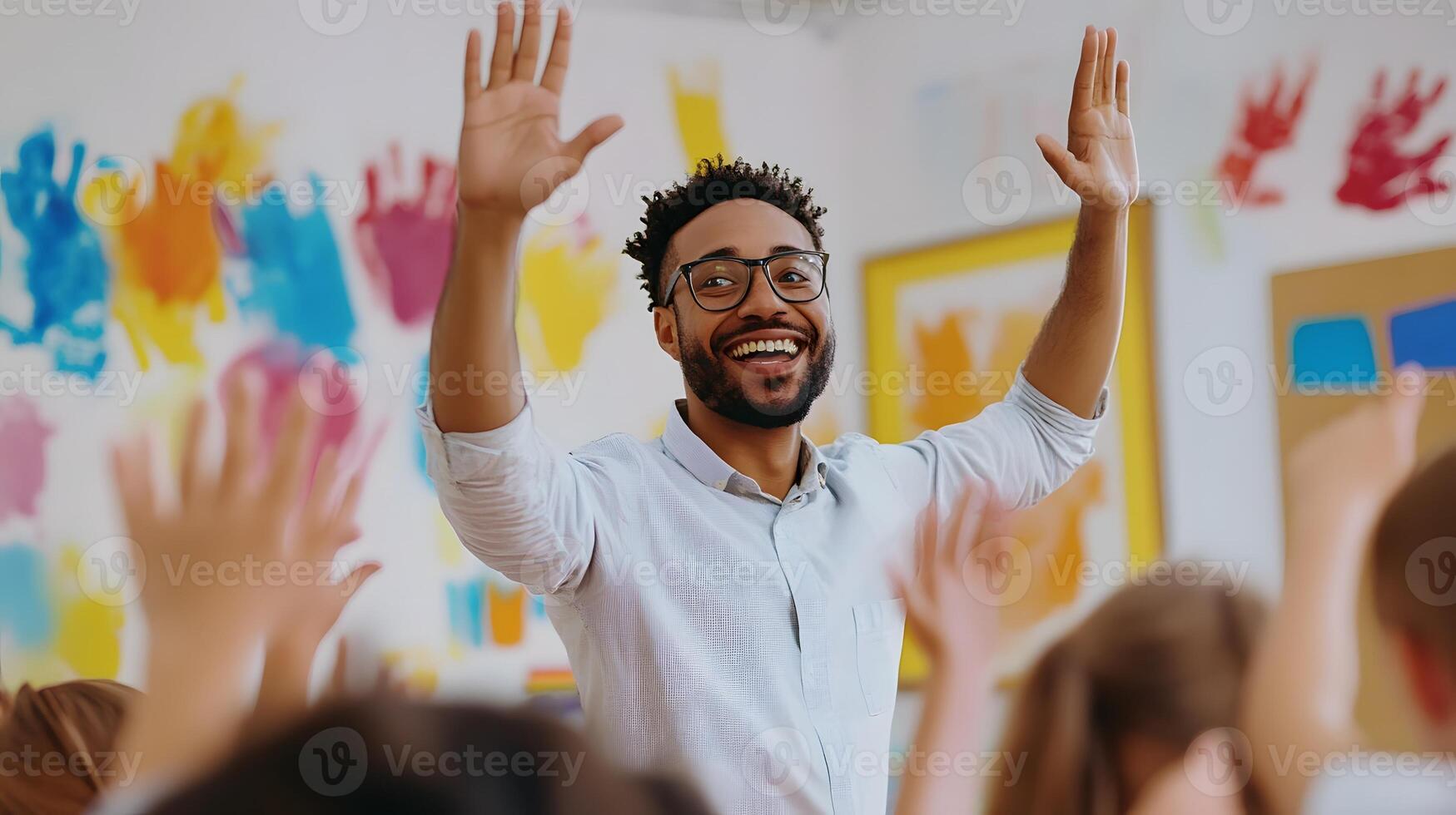 enthusiastic male teacher using colorful visuals during primary school art class photo