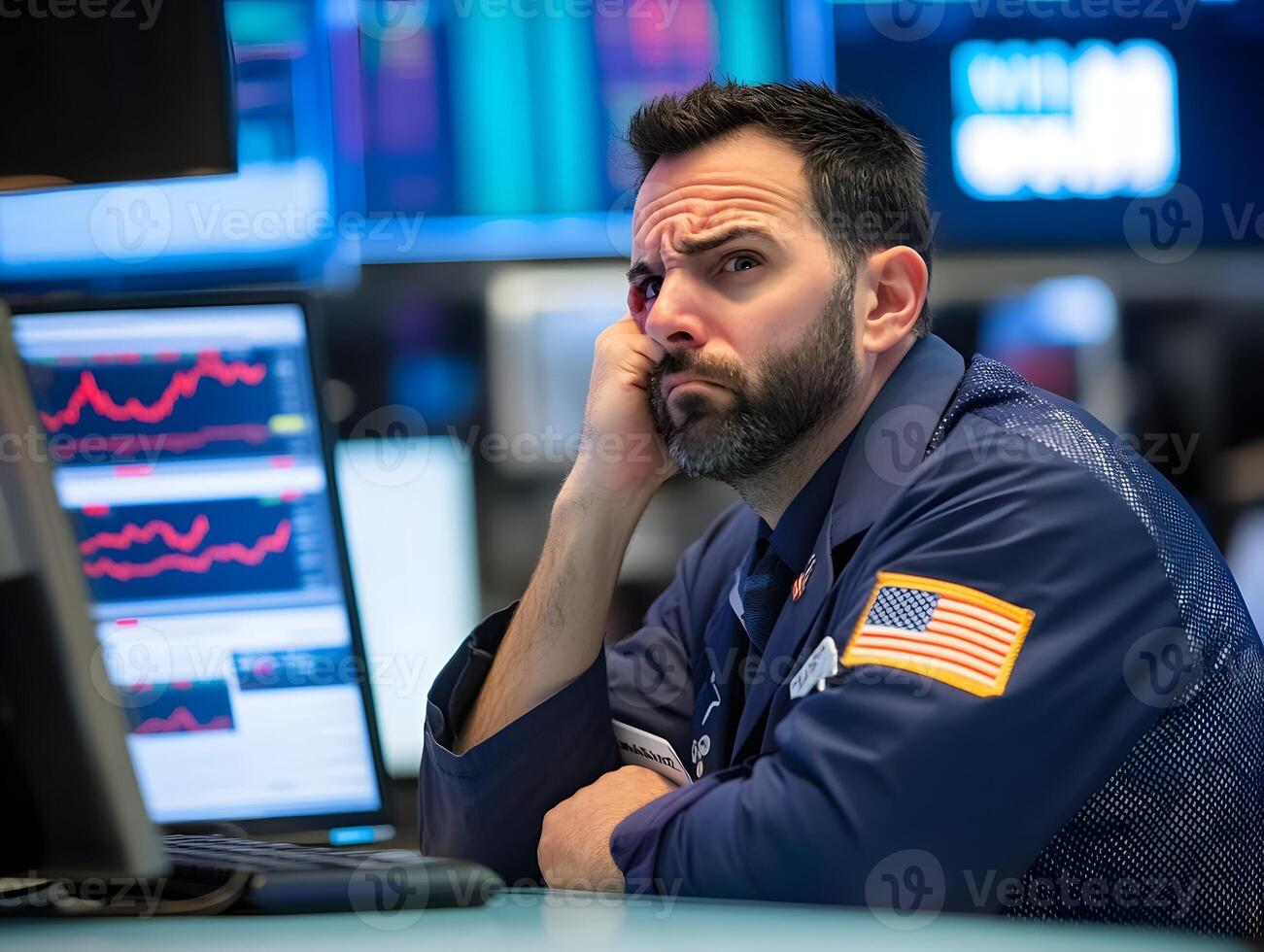 a trader stressed over falling stock prices sitting at a desk photo