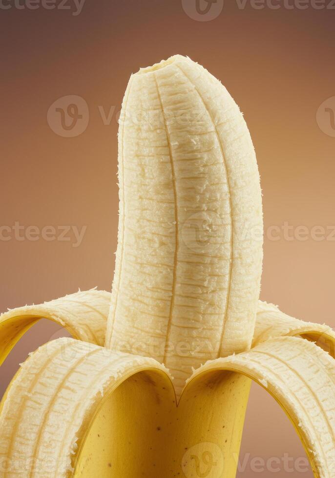 Close up of a partially peeled ripe banana ready for eating or use. photo