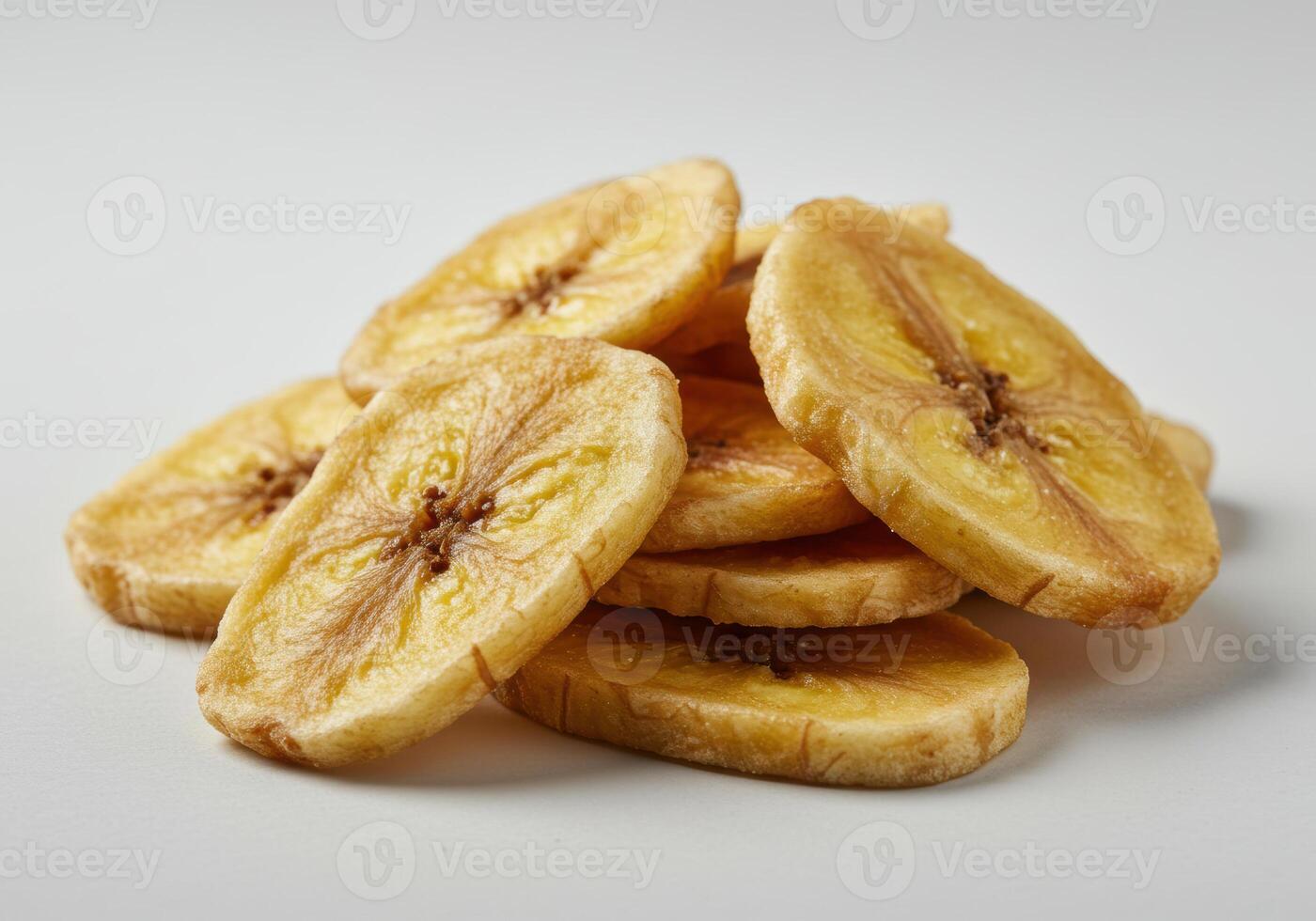 A stack of golden banana chips, offering a close up view of the tasty snack. photo