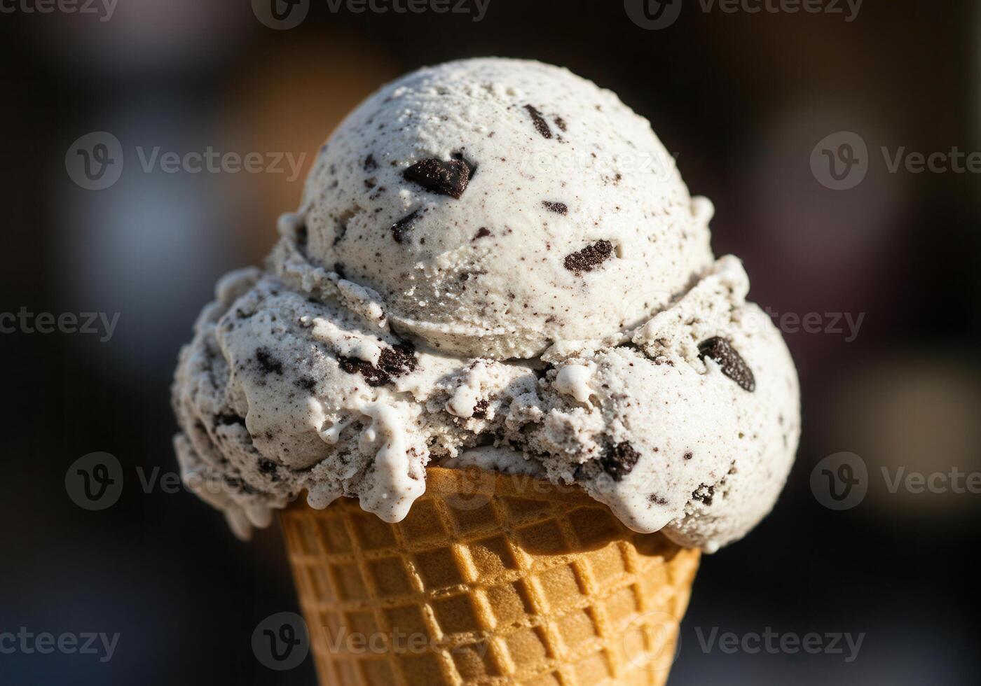 Two scoops of creamy cookies and cream ice cream served on a crisp waffle cone. photo