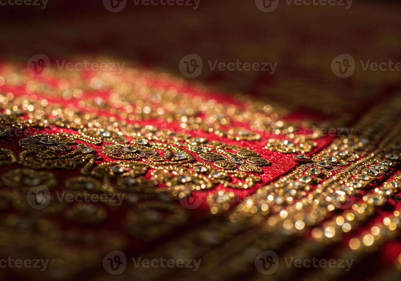 Intricate gold embroidery adorns a vibrant red fabric, creating a luxurious display of detail. photo
