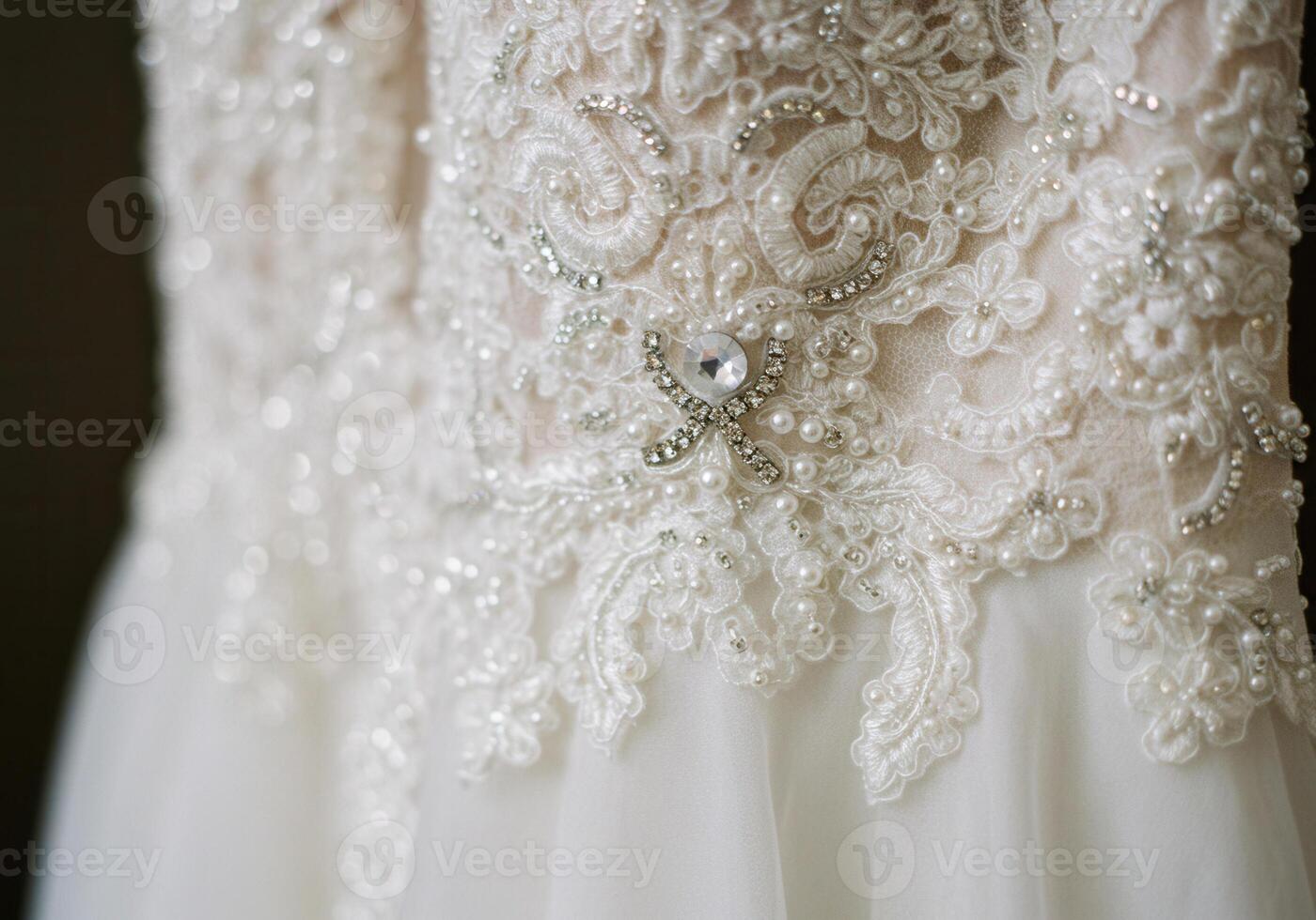 Close-up shot of an elegant white wedding dress with intricate lace and pearl details. photo