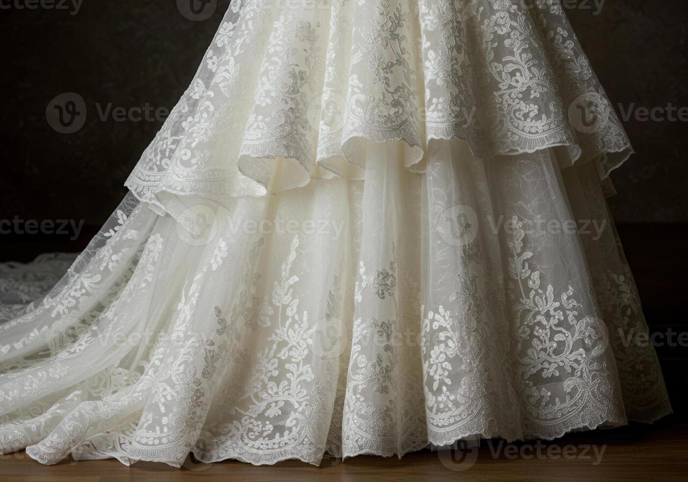 A beautiful close up of a flowing wedding gown with intricate lace detailing. photo