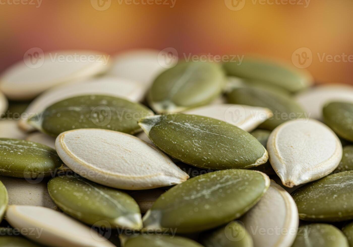 A pile of fresh, green and white pumpkin seeds, perfect for cooking and snacking on. photo
