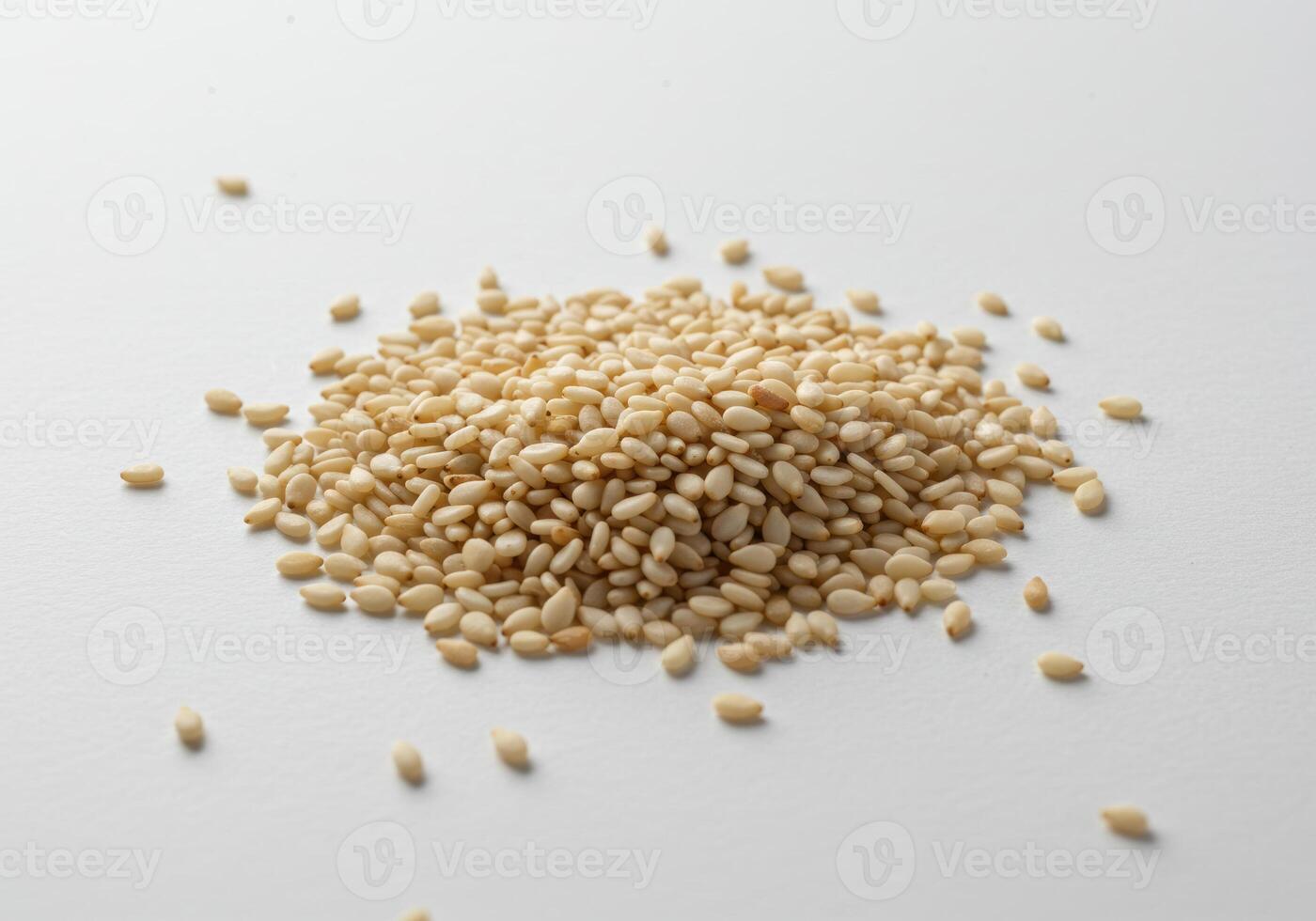 Close up shot of a pile of fresh sesame seeds on a clean white background. photo