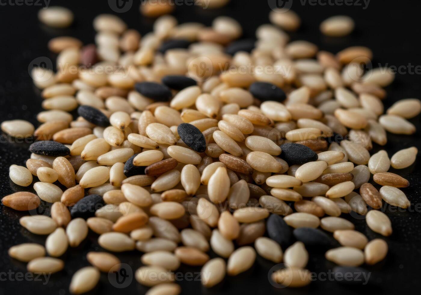 Close up of a pile of mixed sesame seeds, showcasing colors and textures. photo