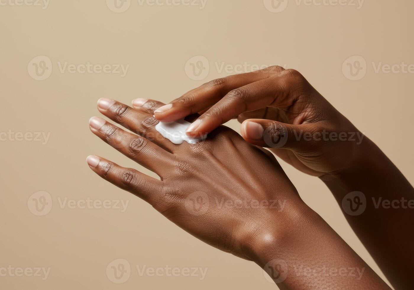 A person's hands are shown applying cream, showcasing a focus on skincare and daily routines. photo