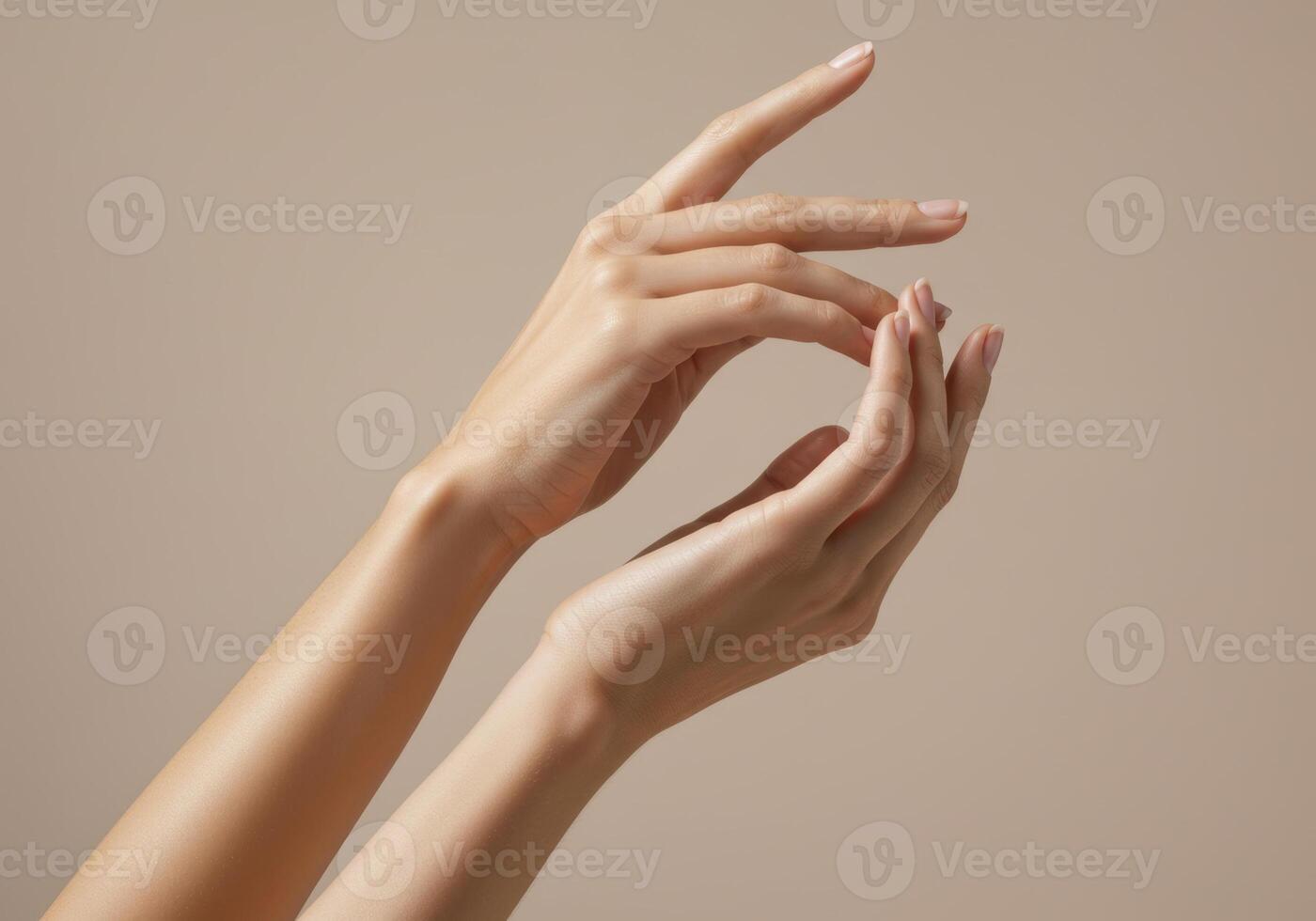 Close up of elegant hands with manicured nails against a soft, neutral backdrop. photo