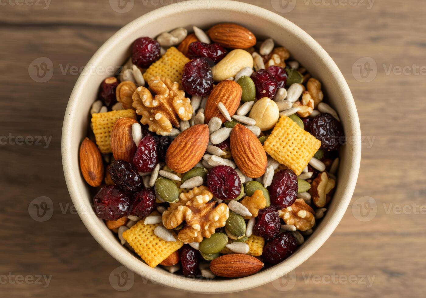 A bowl of assorted nuts, seeds, and dried cranberries, a nutritious and tasty snack. photo
