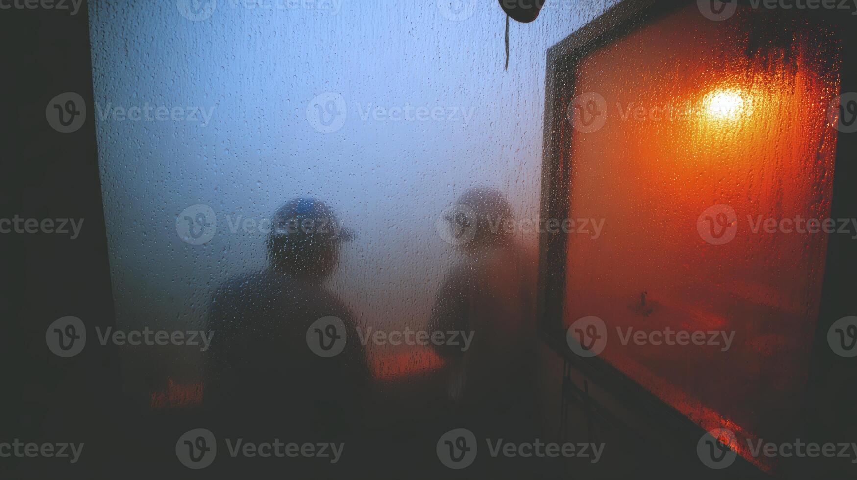 two men stand in the fog at night photo
