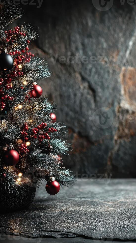 Christmas tree adorned with red ornaments and lights against a textured stone background creates a festive atmosphere in wintertime photo