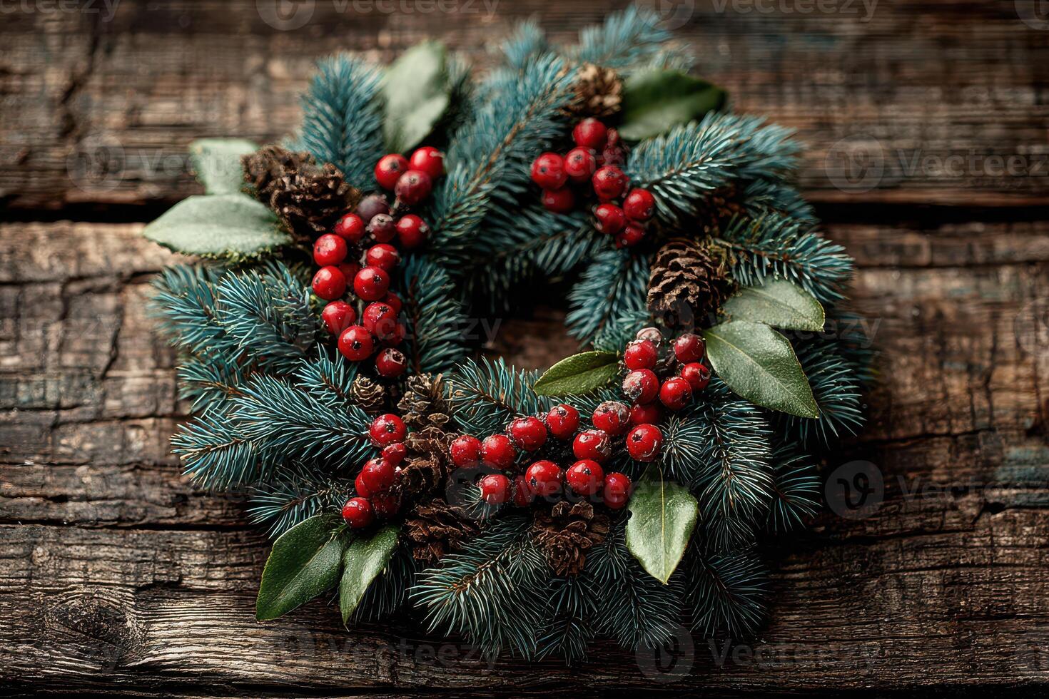 Decorative holiday wreath made of pine branches, red berries, and pinecones on rustic wooden table photo
