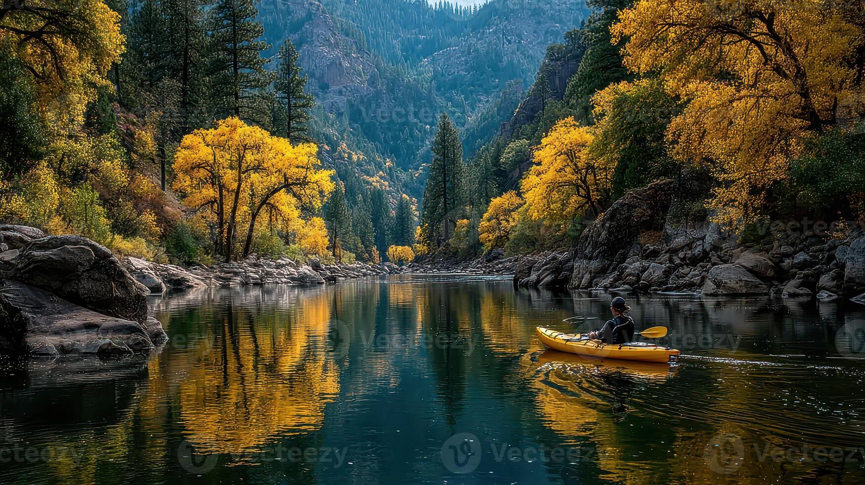 Kayaker exploring a serene river surrounded by vibrant autumn foliage in a peaceful valley photo