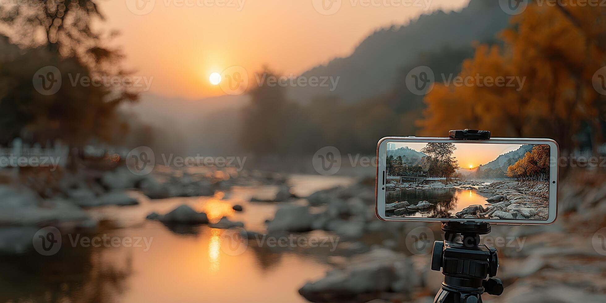 Capturing a serene sunset on a riverbank with a smartphone camera during golden hour photo