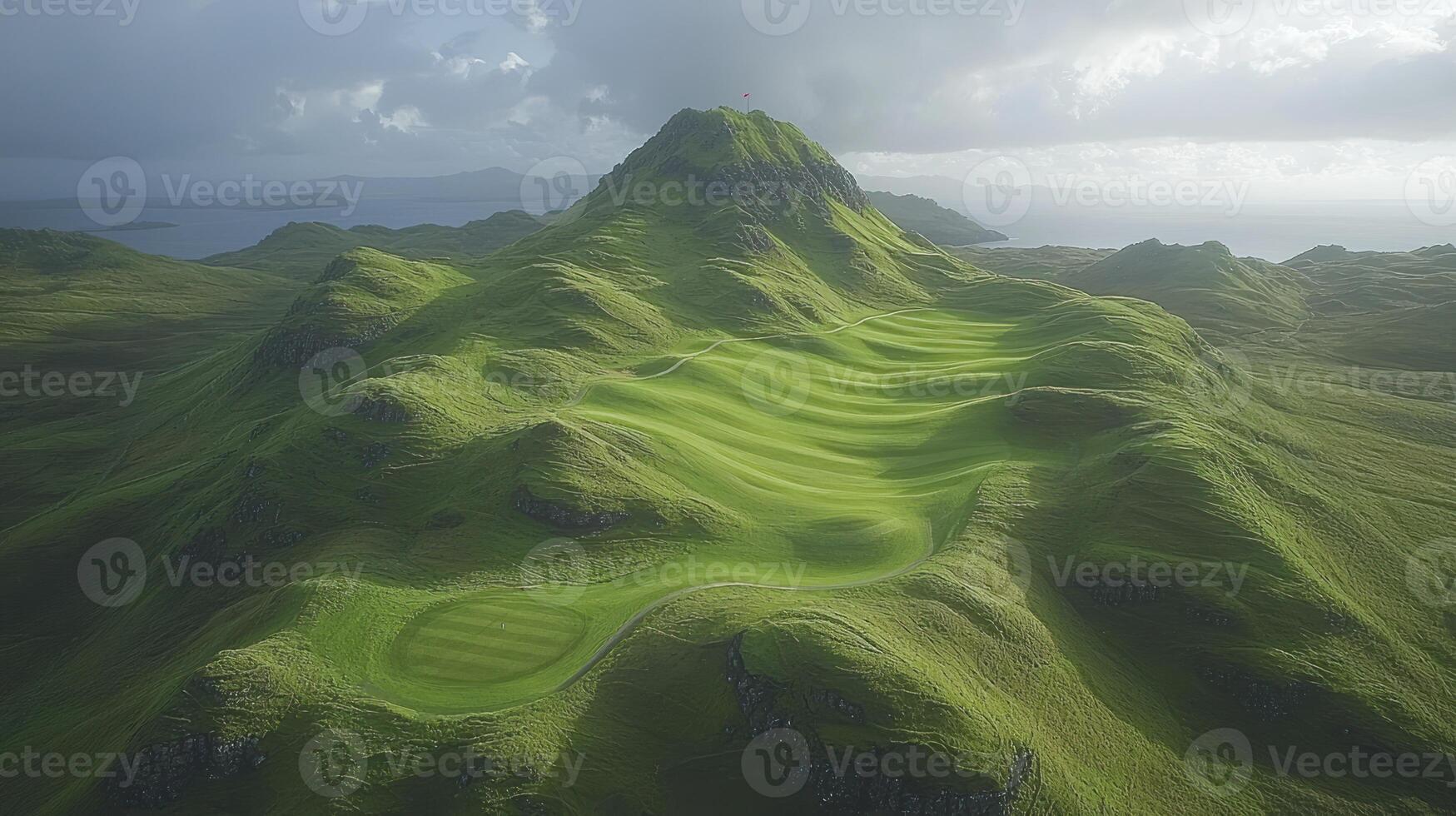 A green golf course with mountains in the background photo