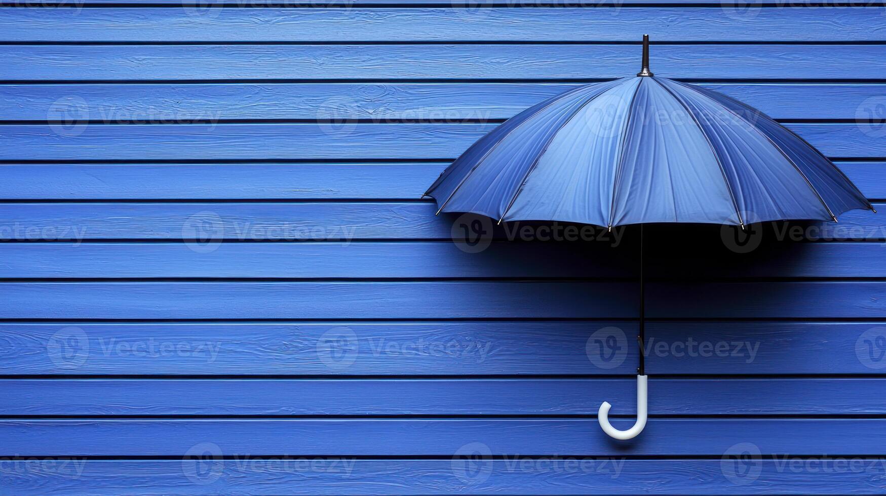A blue umbrella on a wooden wall photo