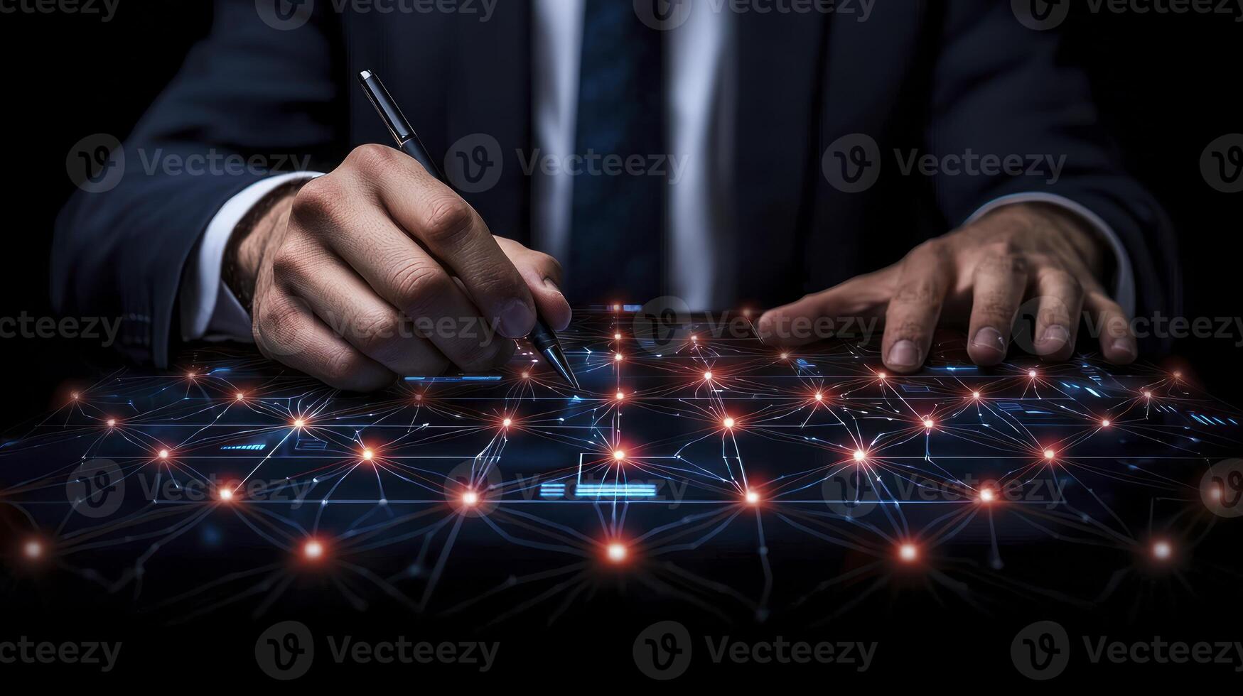 A man in a suit is writing on a tablet photo