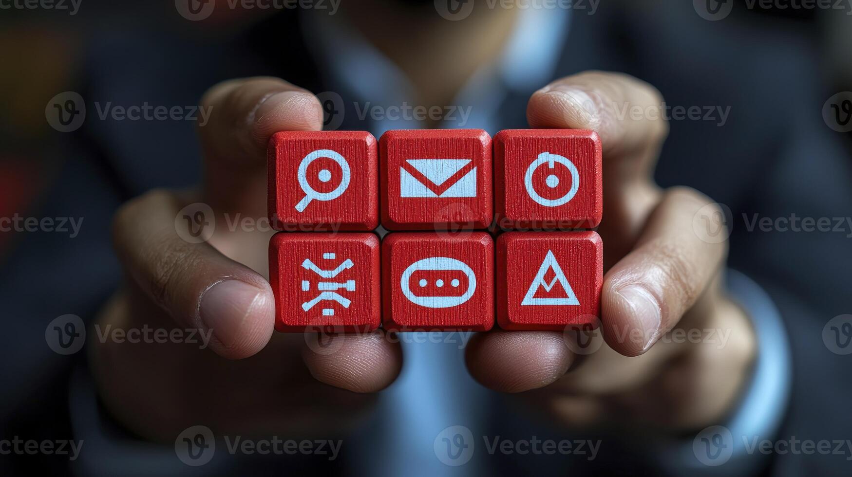 A person holding red cubes with icons on them photo