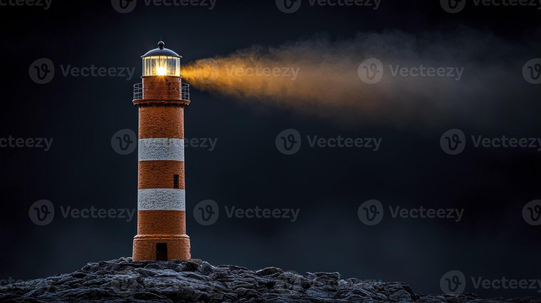 A lighthouse is lit up on a dark night photo