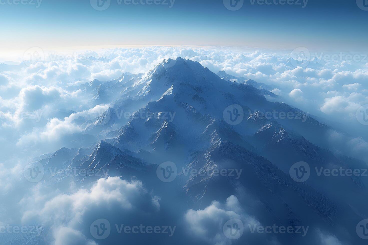 Majestic Snow-Covered Mountain Peaks Emerging Through Clouds photo