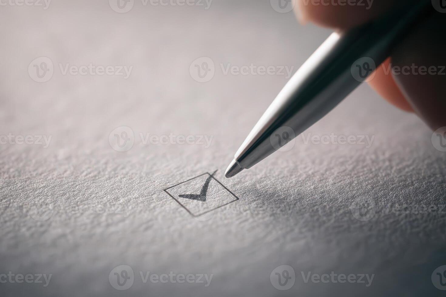 A persons hand grips a silver pen, making a precise checkmark inside a small empty box on white paper, signifying task completion during a planning or organizing session. photo
