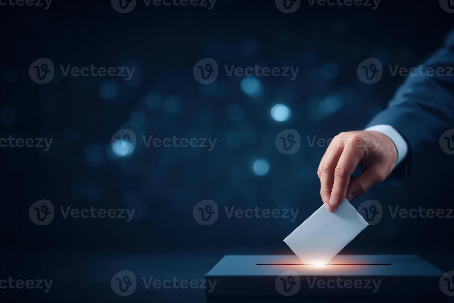A hand reaches forward to place a ballot into a dark ballot box, symbolizing civic duty and participation in the democratic process during a crucial election moment. photo