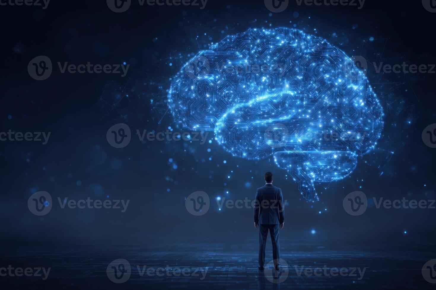 A person stands in front of a glowing digital brain outline, depicting the connection between human intelligence and technology. photo