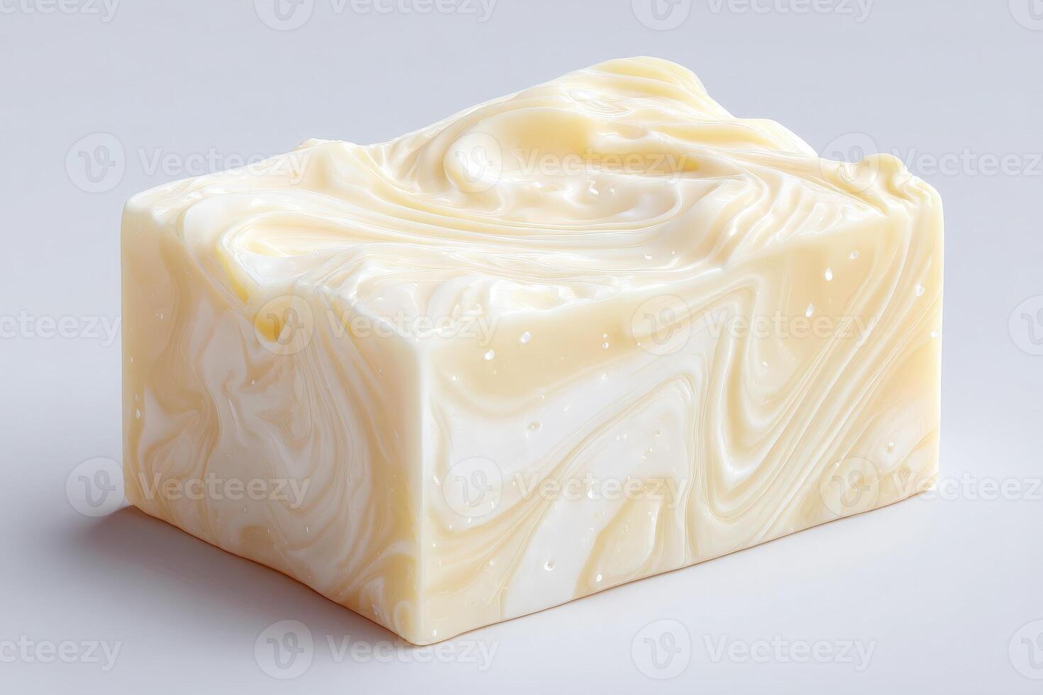 A beautifully crafted rectangular block of handmade soap features creamy white and beige swirls. The smooth texture hints at its moisturizing properties, making it suitable for personal care. photo