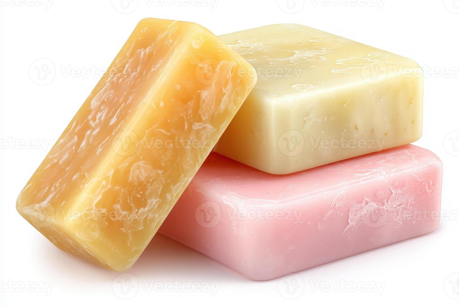 Three bars of natural handmade soaps in yellow, pink, and cream are displayed on a clean white background. Each bar showcases a unique texture, ideal for skincare and personal care routines. photo