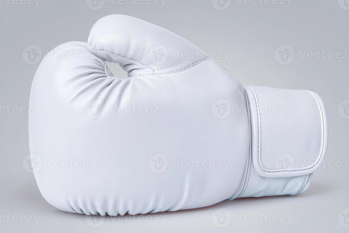 A white boxing glove is positioned to highlight its round shape and padded surface. The glove displays clean lines and a smooth texture, emphasizing its professional quality and craftsmanship. photo