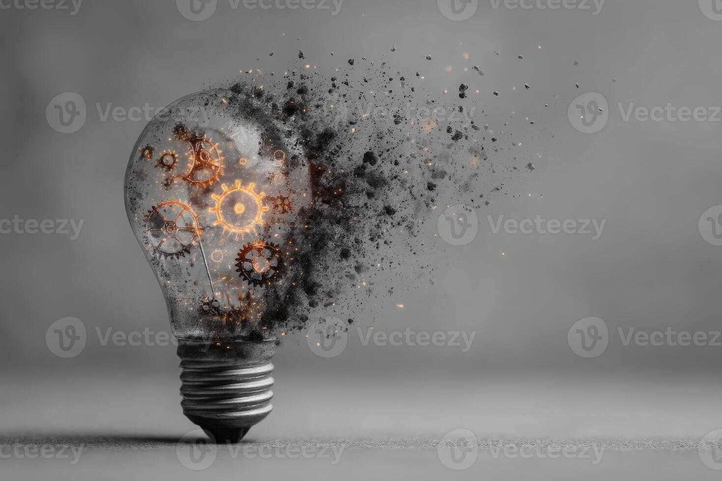 A light bulb filled with gears appears to be shattering, emitting bright light and particles. photo