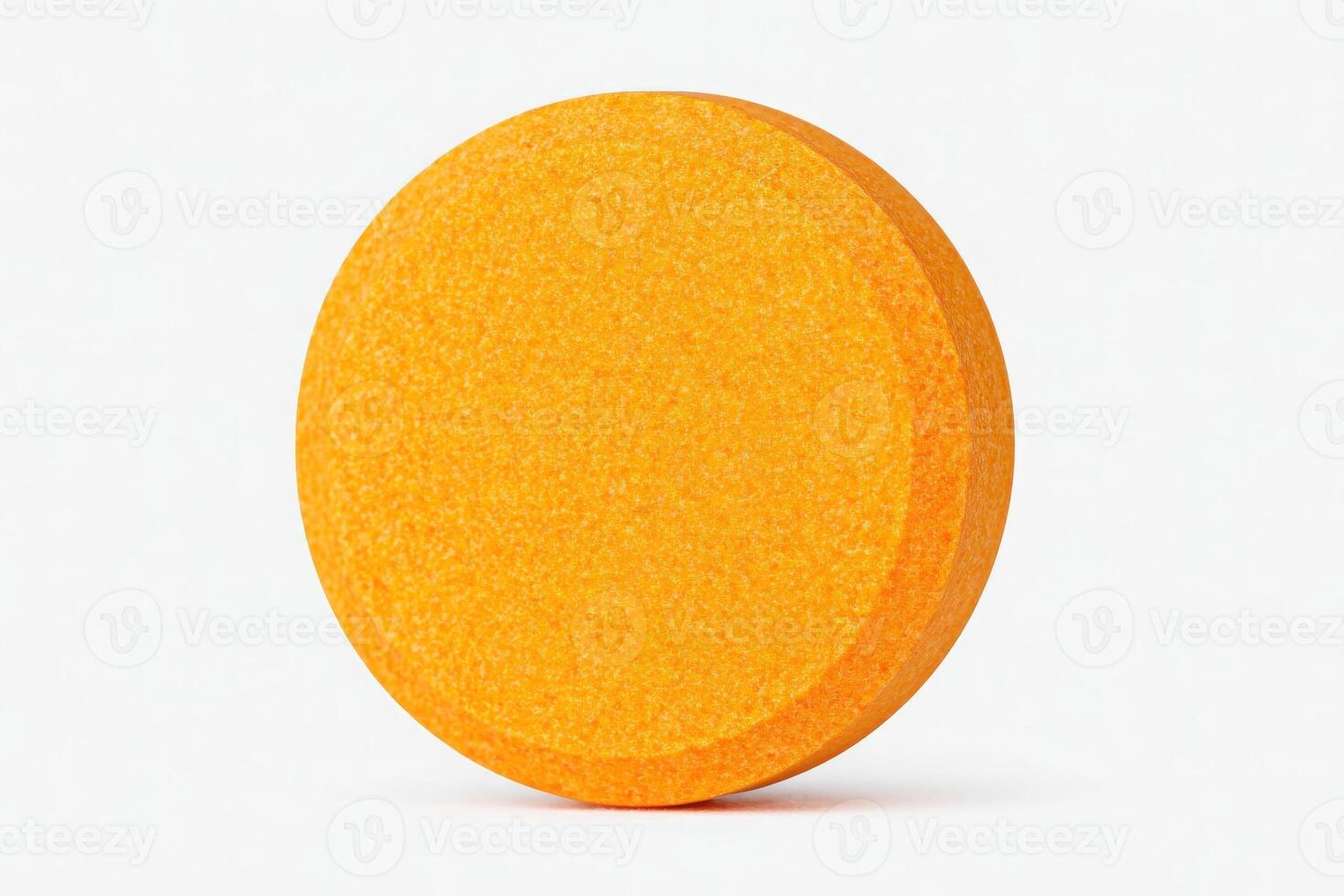 A round orange tablet is displayed on a clean white surface. Its smooth texture and bright color make it stand out. The focus on the tablet highlights its size and design. photo