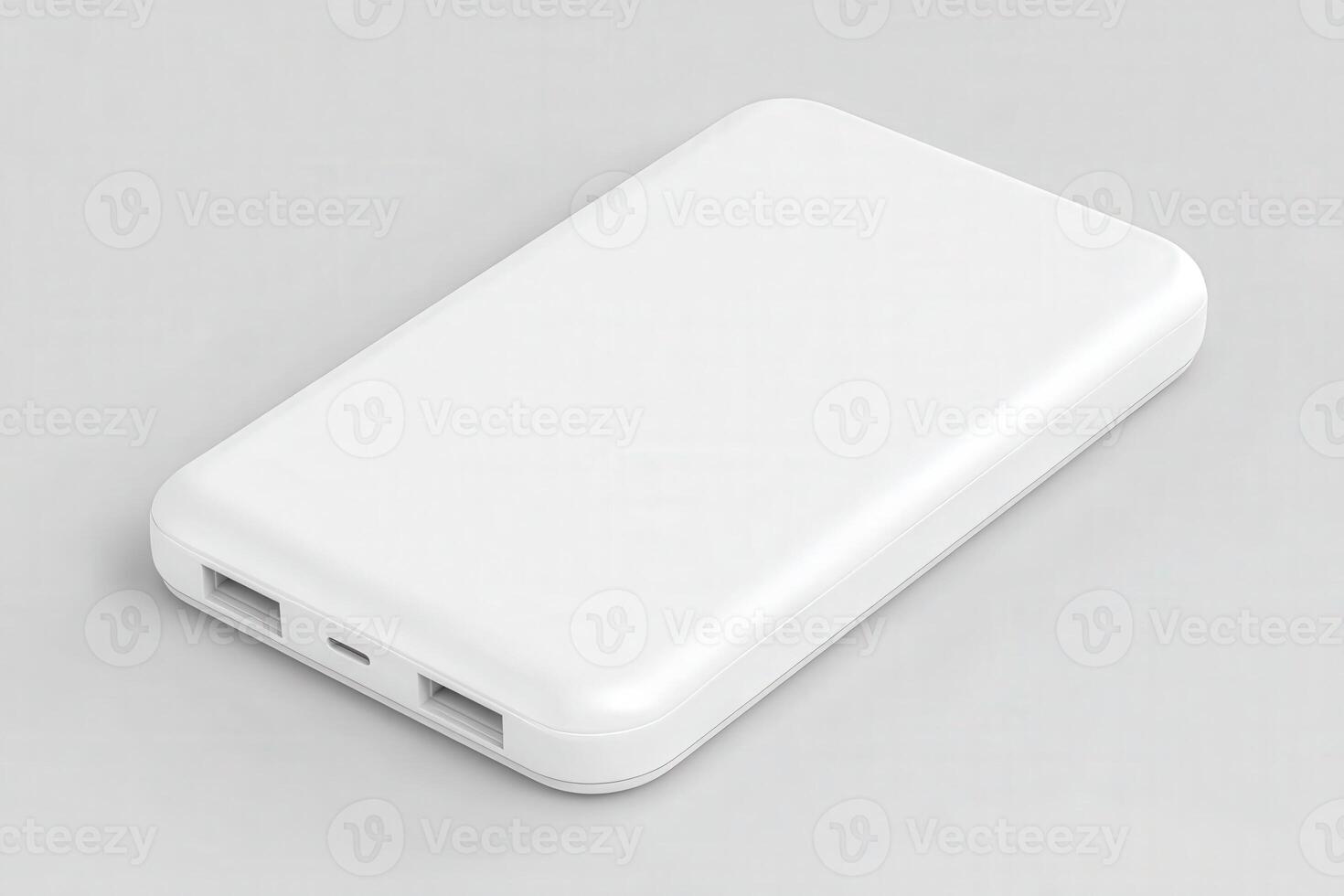 A white portable power bank rests on a gray background, featuring dual USB ports for charging devices. Its sleek design makes it a handy accessory for on-the-go charging. photo
