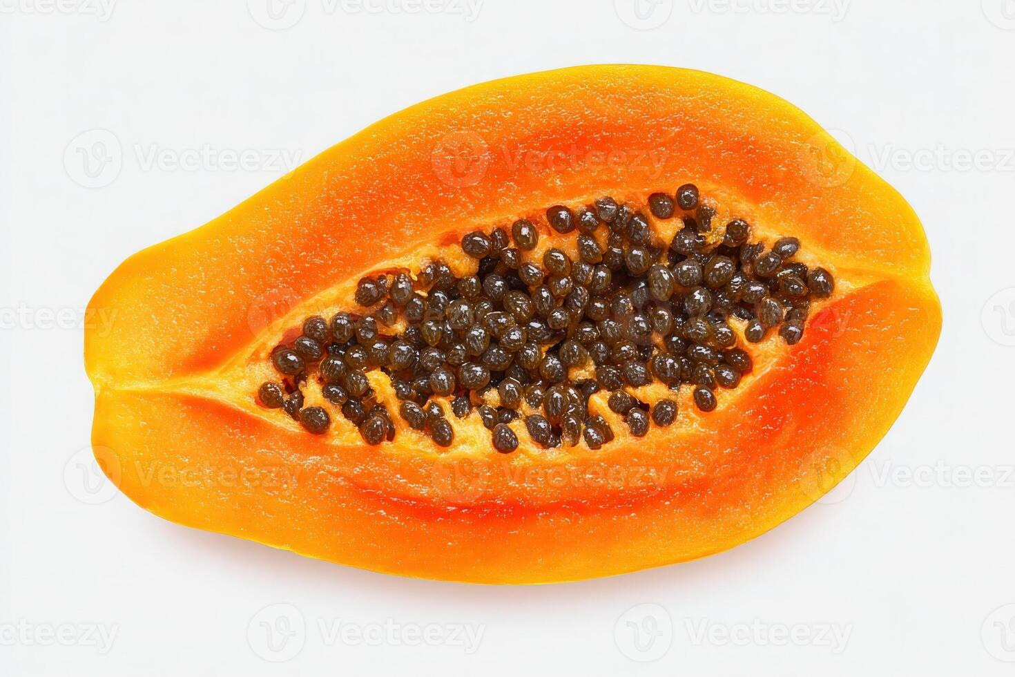 This ripe papaya is sliced in half, revealing its bright orange interior dotted with small, glossy black seeds. The fruit is fresh and ready for culinary use or consumption. photo