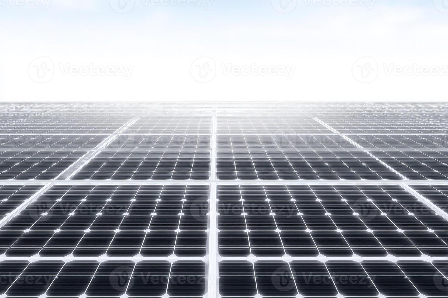 Rows of solar panels stretch across a flat surface, absorbing sunlight beneath a bright blue sky. This renewable energy setup showcases sustainable technology and efficiency. photo
