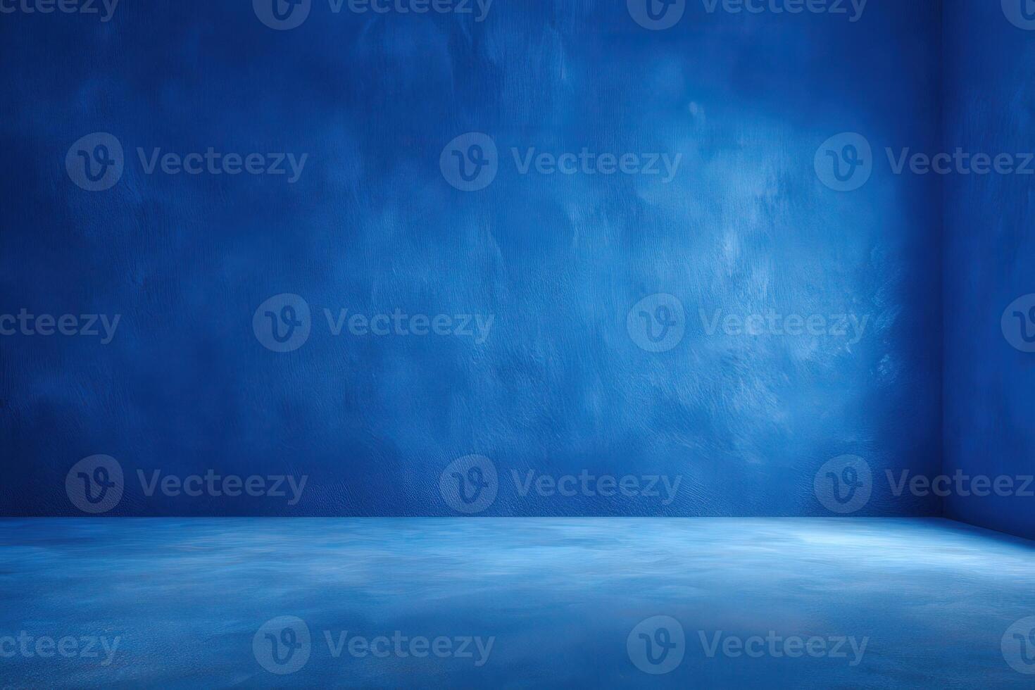 A striking bright blue interior space features textured walls and a smooth floor. Soft light enhances the color, creating a tranquil atmosphere, perfect for artistic expression or relaxation. photo