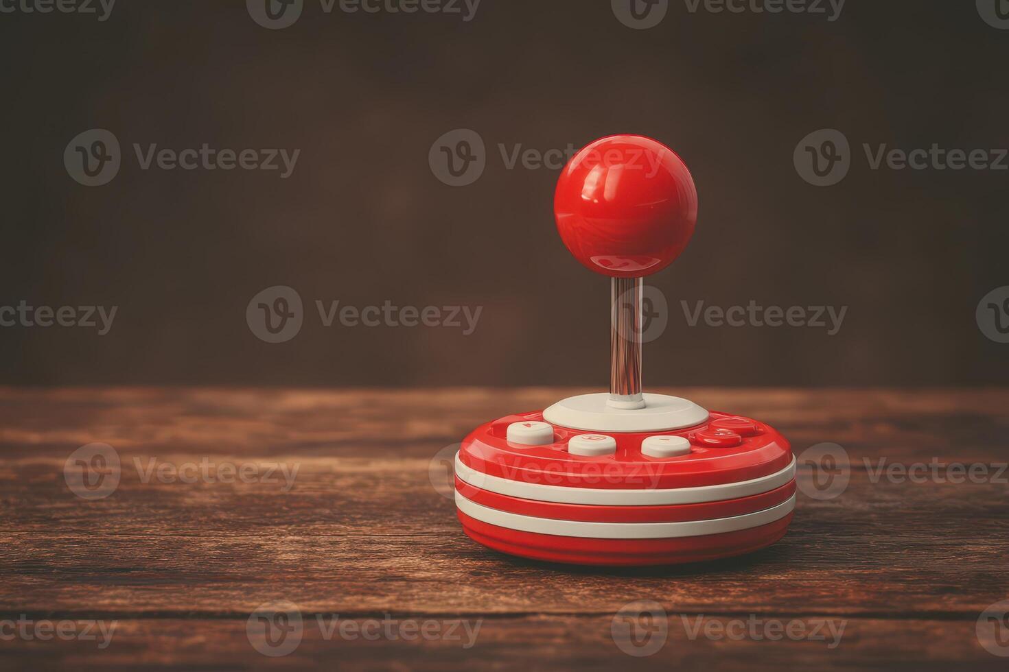 A vintage red and white joystick controller rests on an aged wooden surface. Soft lighting enhances its nostalgic appeal, evoking memories of classic gaming from the past. photo