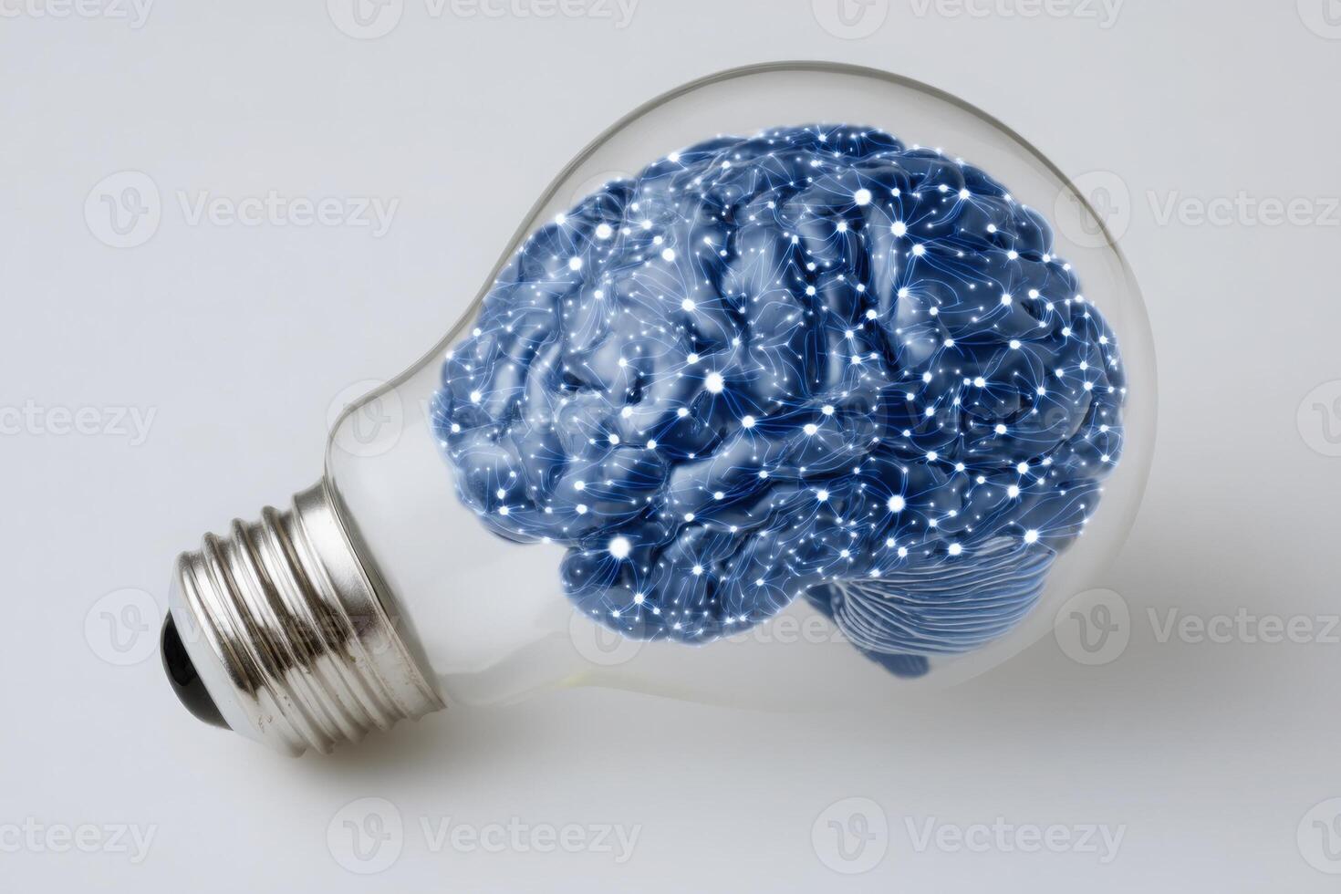 A light bulb filled with a blue brain highlights the concept of creativity and intelligence. photo