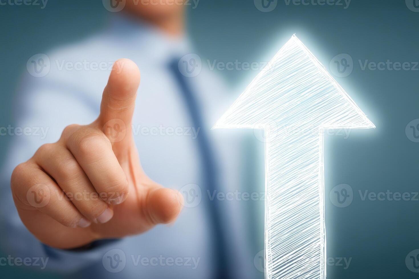 A persons hand is extending forward, pointing at a glowing arrow that symbolizes upward motion. photo