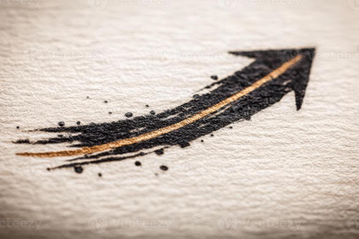 A sleek arrow graphic in black and gold features a textured paper background. The design conveys energy and movement, suitable for design projects and creative themes. photo