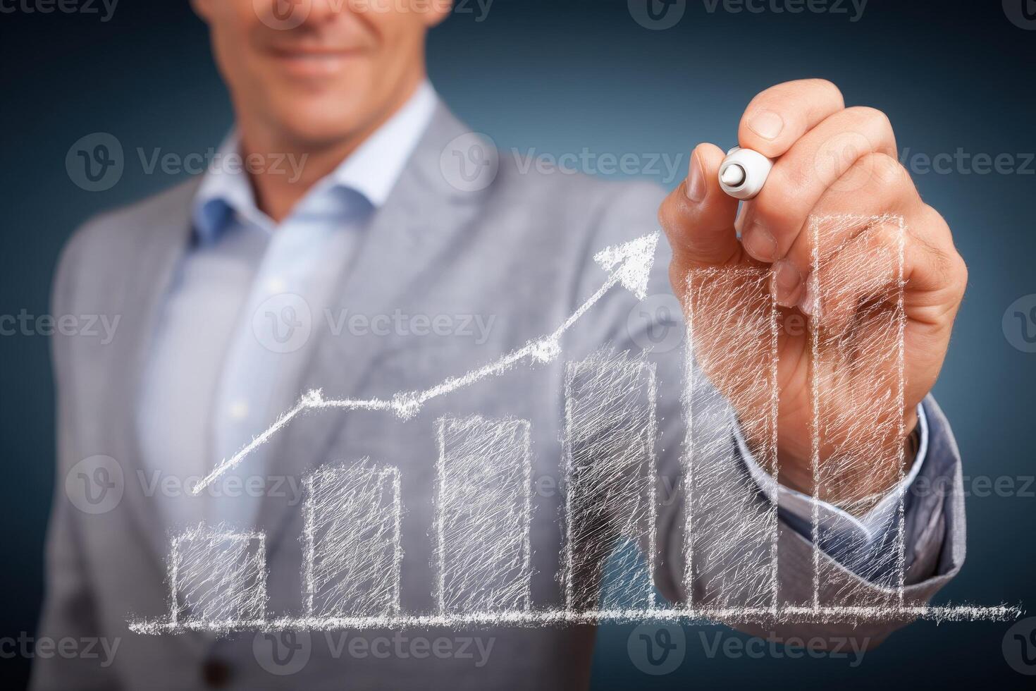 A businessman in a gray suit is drawing upward trending charts on a dark background. The visuals represent growth and success, symbolizing strategic planning and finance. photo