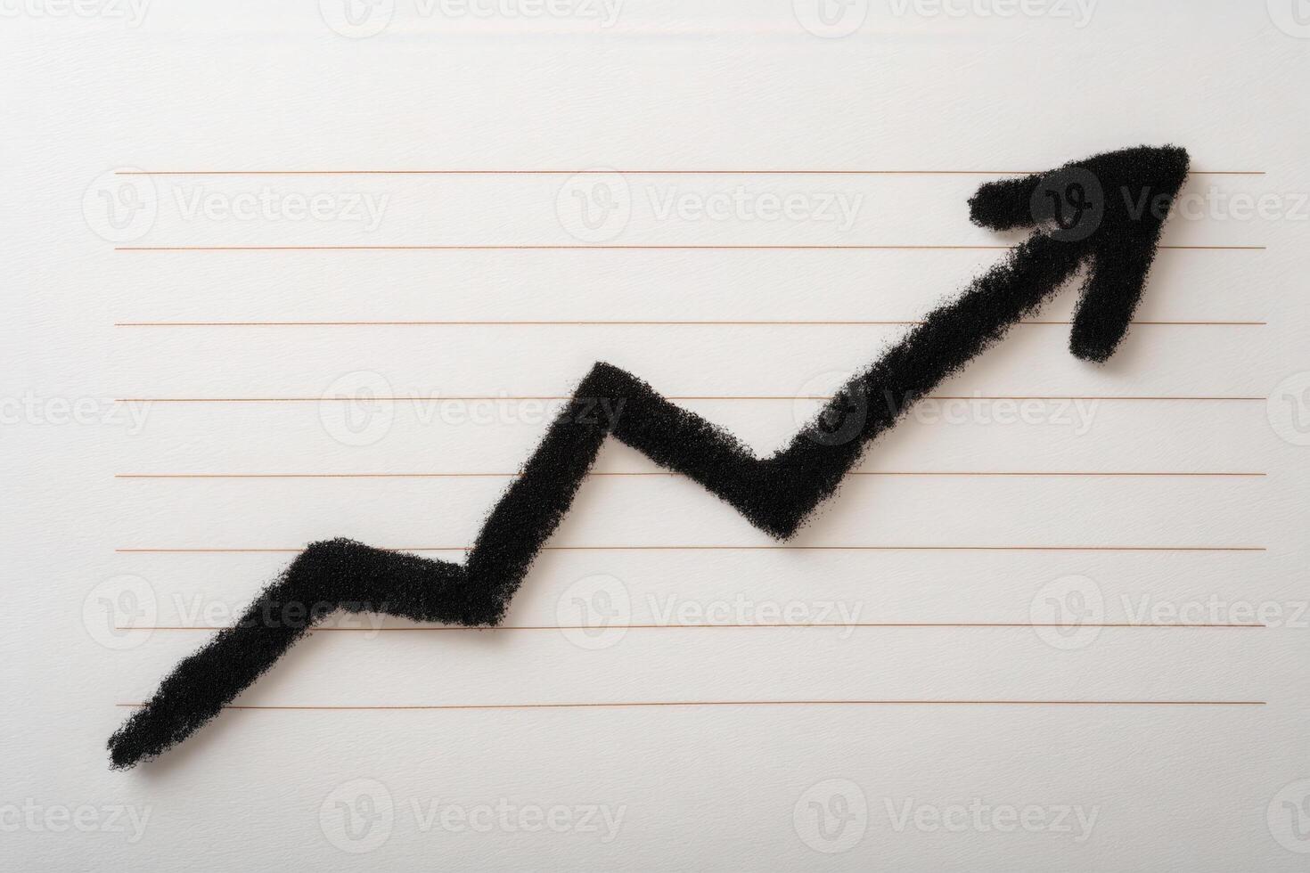 A black chalk line illustrating a zigzagging growth trend is drawn on a sheet of lined paper. The line emerges from the bottom left, rising toward the upper right, signifying upward progress. photo