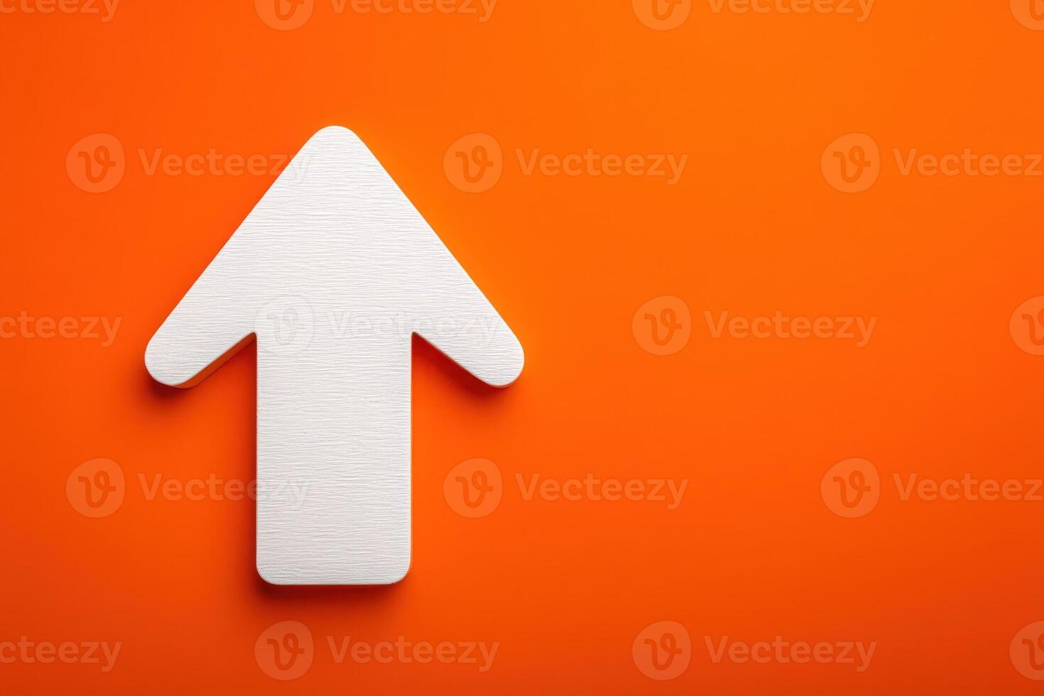 A white arrow points upwards against a bold orange background, creating a striking visual contrast. The design suggests movement and directionality, perfect for guiding attention. photo
