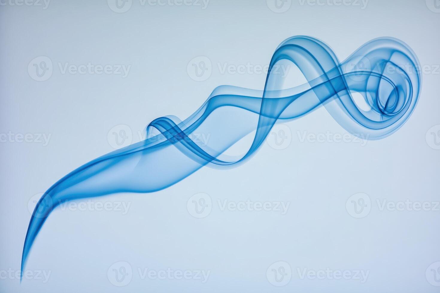 A graceful and ethereal swirl of blue smoke drifts through the air, captivating attention with its fluid motion on a soft, light backdrop. The delicate patterns evoke a sense of calm and tranquility. photo