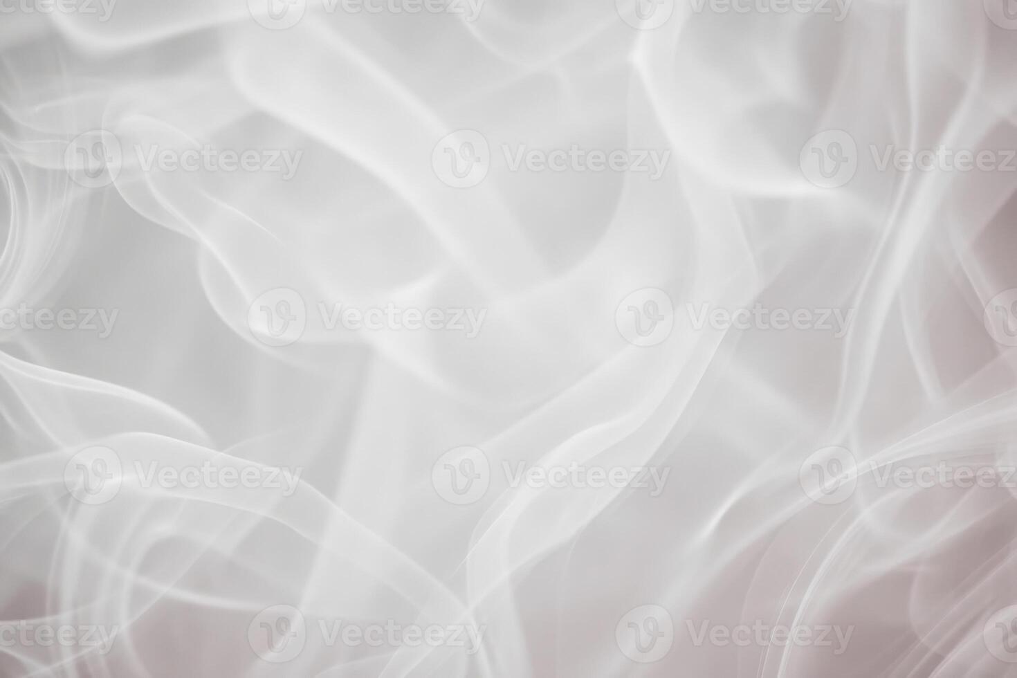 Delicate white smoke gracefully swirls and intertwines, creating a soft, ethereal atmosphere against a subtle light backdrop. This gentle movement evokes a feeling of calm and tranquility. photo