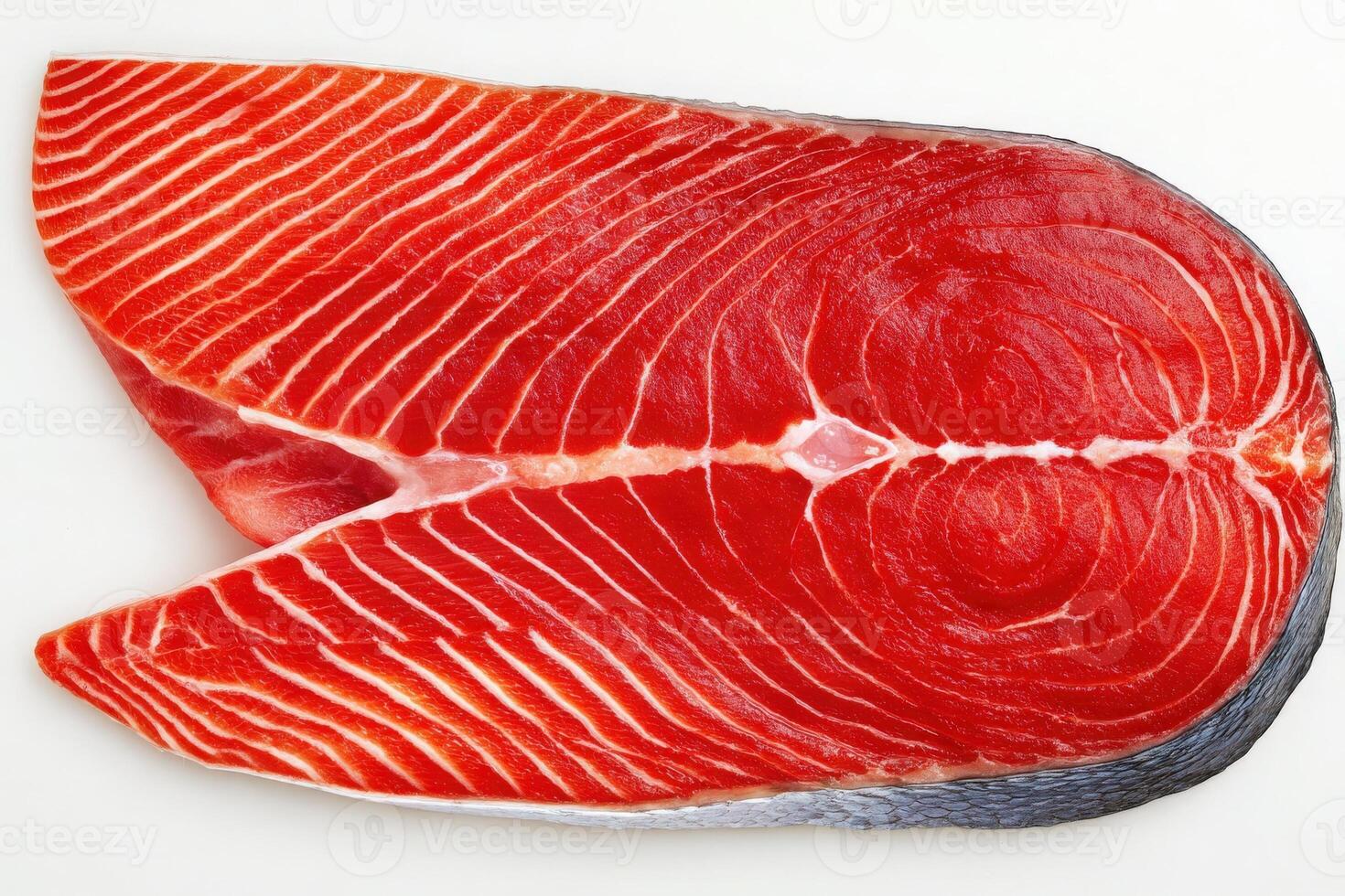 This freshly cut salmon fillet displays a rich red hue and stunning marbling. The texture reveals the quality of the fish, making it ideal for culinary dishes and presentations. photo
