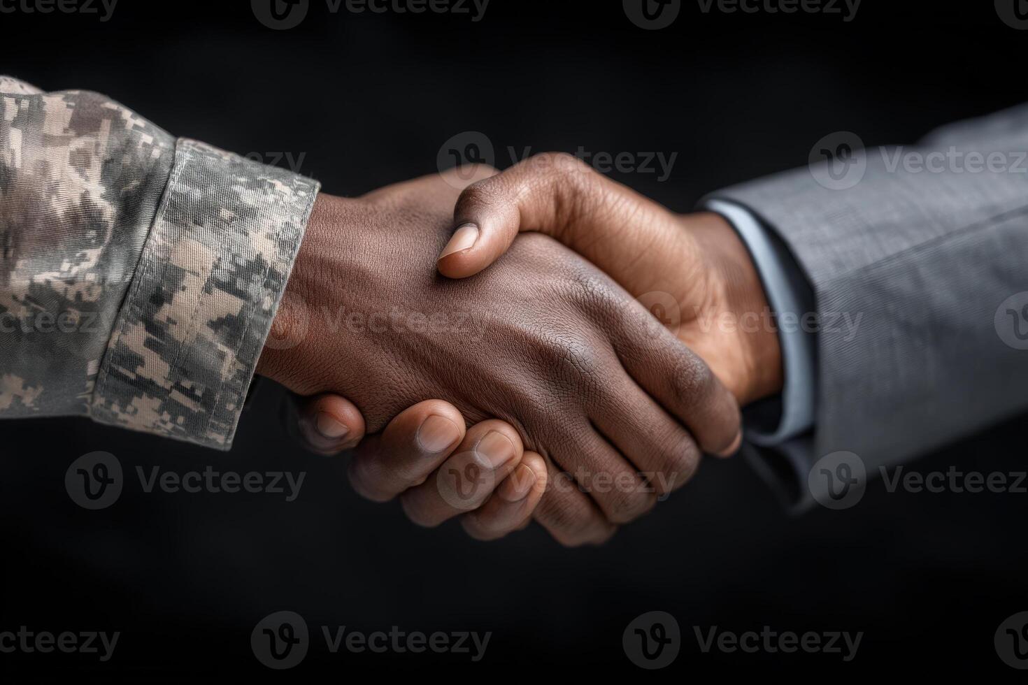 Two hands shake firmly, symbolizing unity and cooperation. One hand belongs to a soldier in military uniform, while the other belongs to a civilian in formal attire. photo