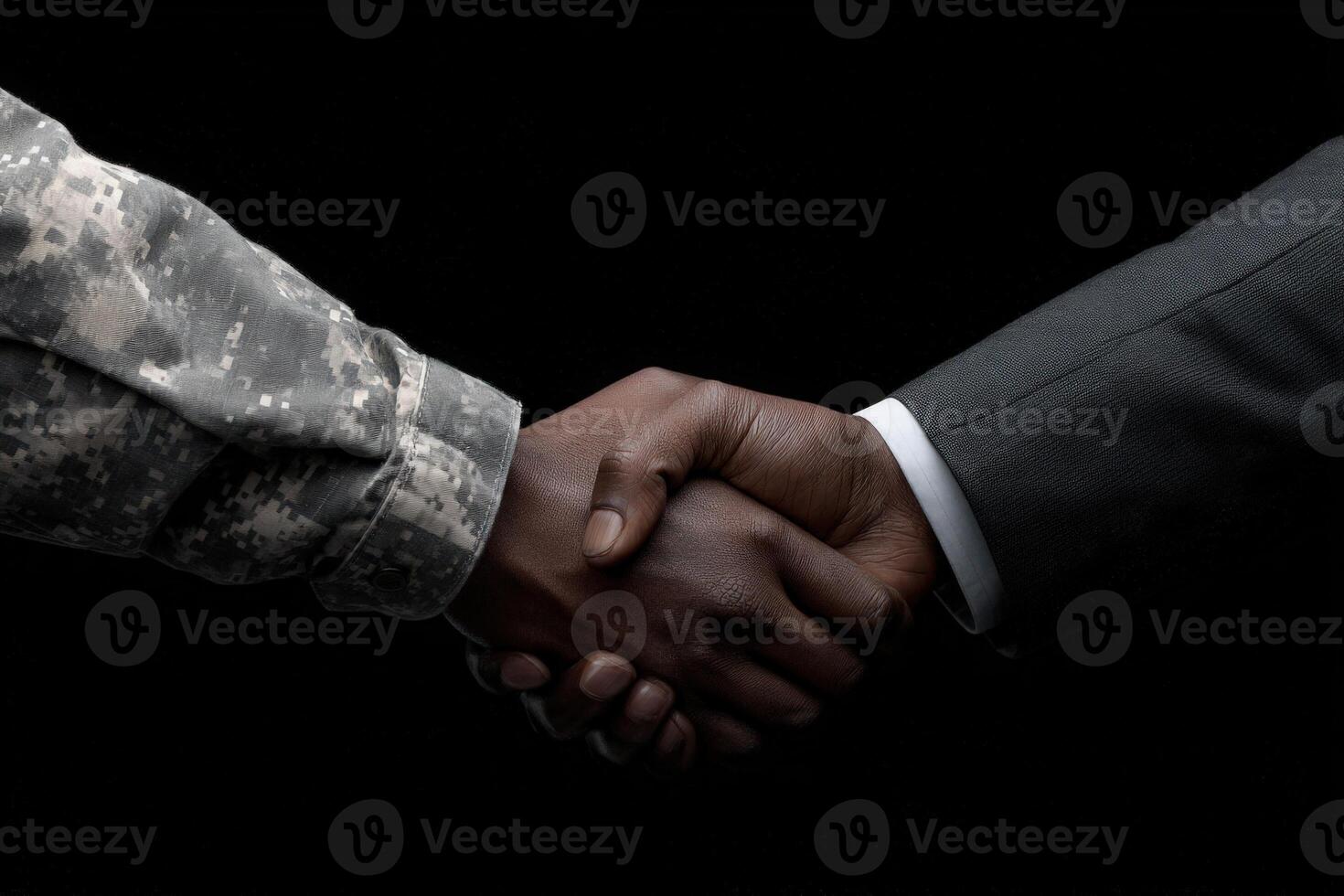 A close-up view of two hands shaking, one wearing a military uniform and the other in a formal suit. This gesture illustrates the connection between the armed forces and civilian life. photo