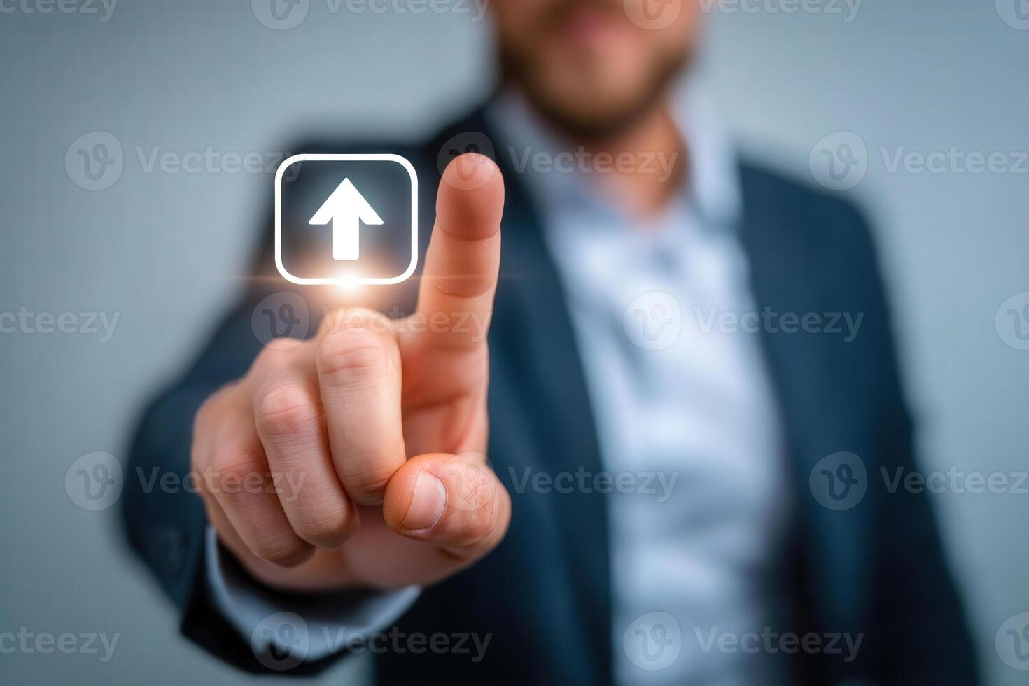 A businessman in a suit interacts with a visual digital interface, pressing an upward arrow icon on a touchscreen. The setting suggests a modern office environment during a professional meeting. photo
